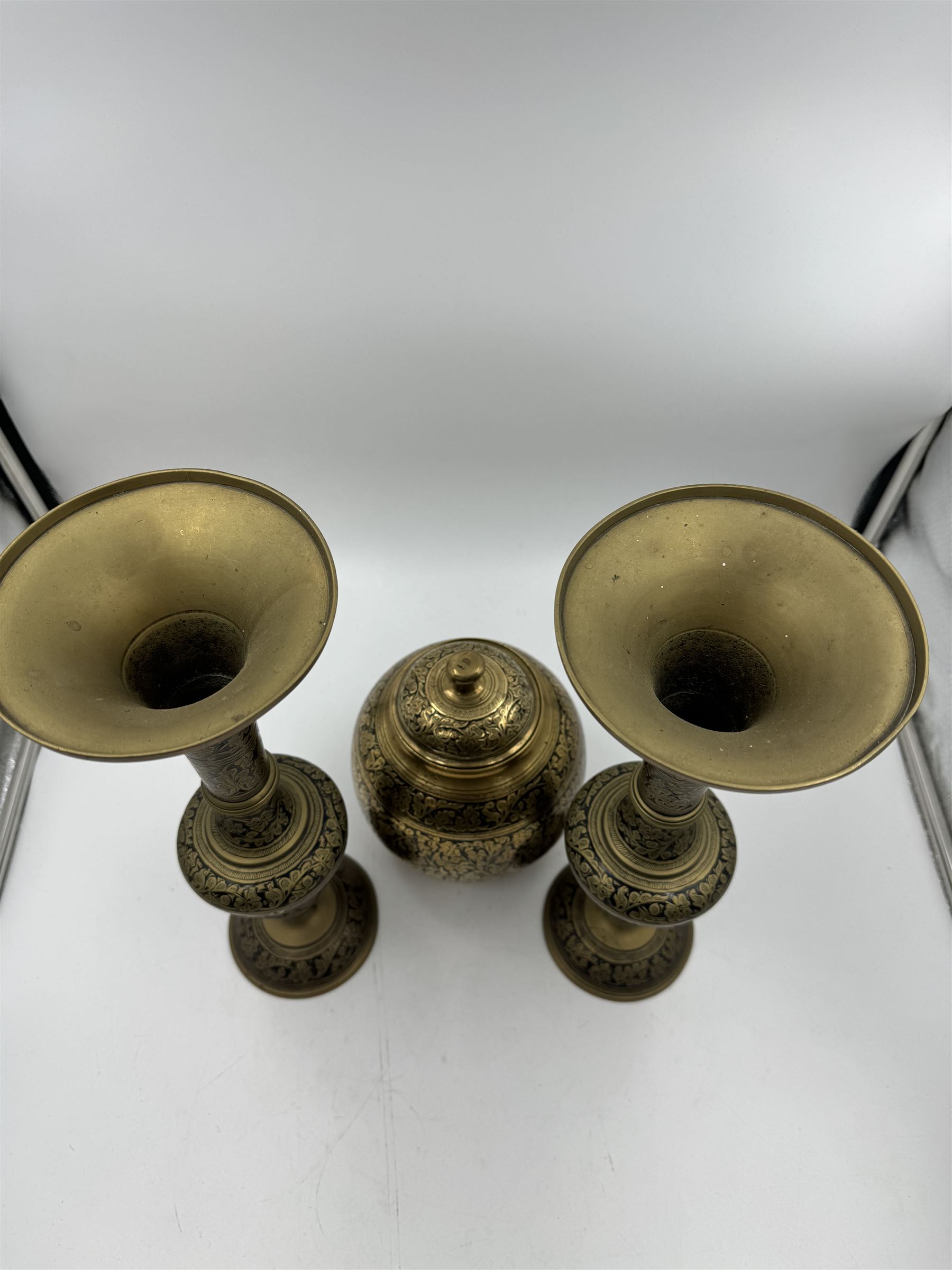 Pair of Cairo Ware vases, each of trumpet form, with foliate and black enamel decoration, together with a similar jar and cover, vases H33cm