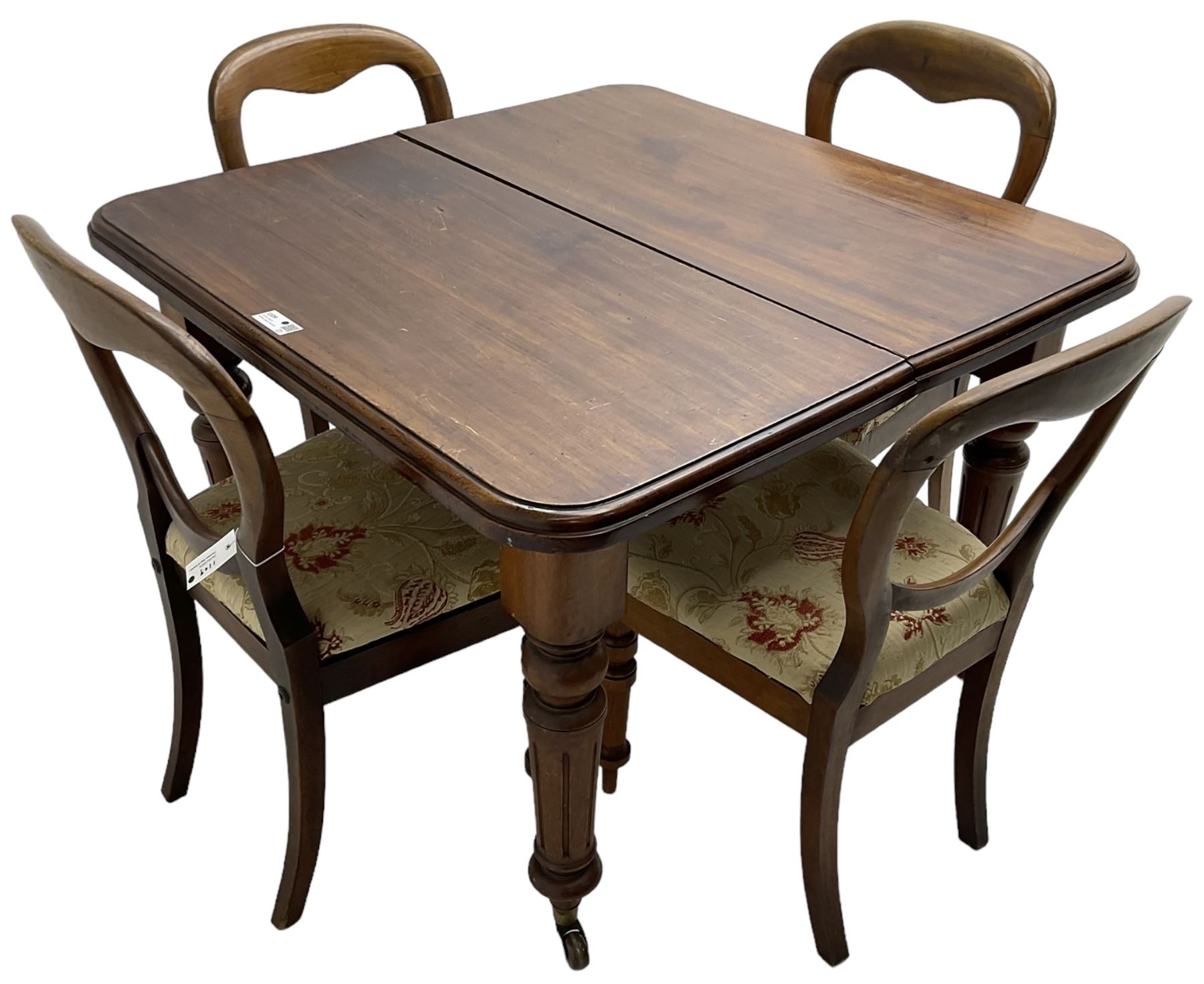 Victorian mahogany dining table, telescopic extending action, moulded rectangular top with rounded corners, single additional leaf, on turned and fluted supports with brass and ceramic castors; and a set of four Victorian mahogany dining chairs, balloon back over upholstered drop-on seat in floral pattern fabric, on turned front supports 