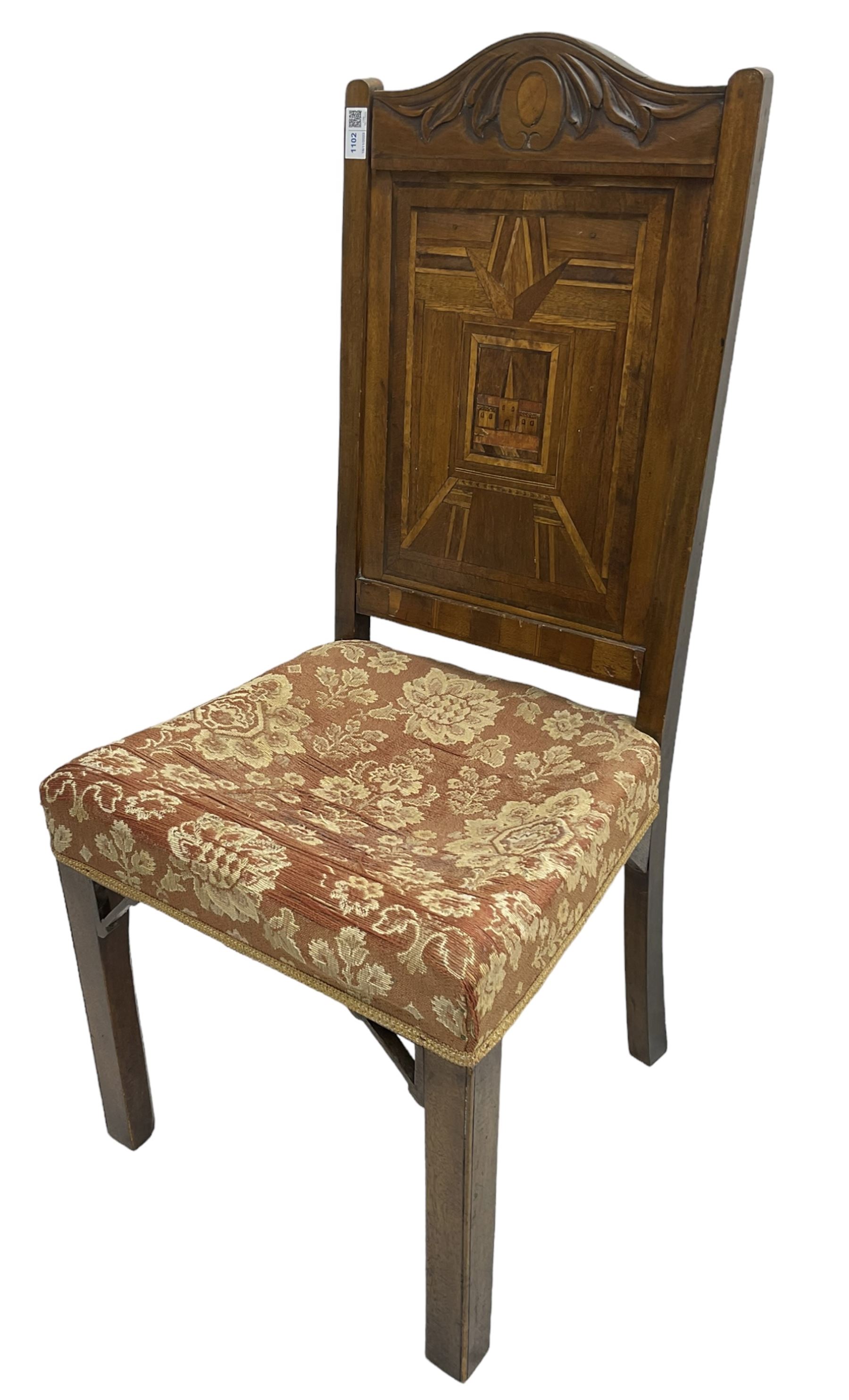 19th century walnut side chair, foliage carved cresting rail over geometric inlaid back with central panel depicting buildings, upholstered seat, on moulded and chamfered square supports