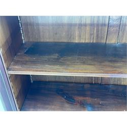 Early 20th century mahogany bookcase, projecting dentil cornice over blind fretwork frieze, enclosed by two astragal glazed doors, on shaped bracket feet 