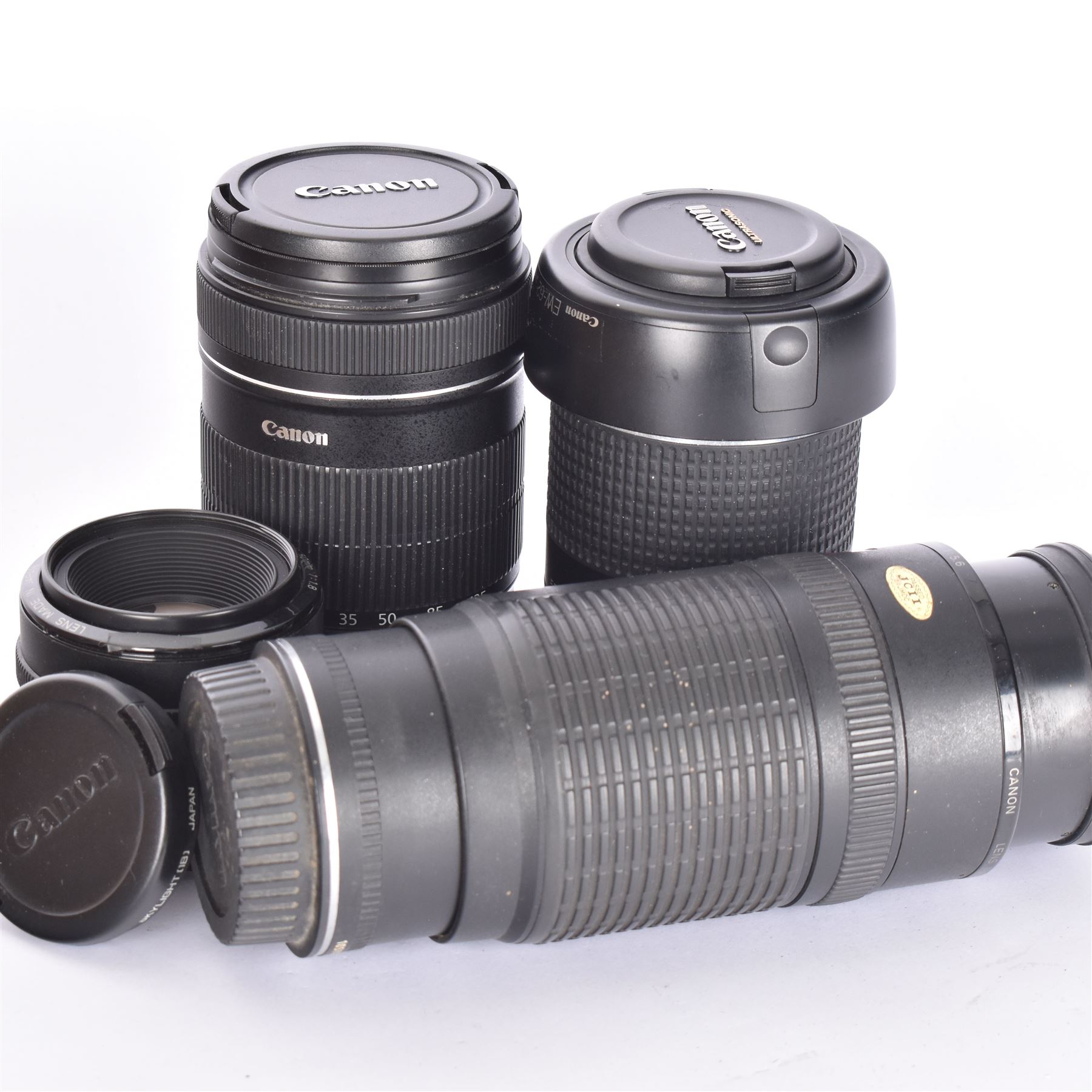 Three Canon EF camera lenses, comprising 100-300mm 1:5.6 lens serial no. 1057918, 50mm 1-1.8 lens serial no. 1153183 and a 55-200mm 1:4.5-5.6 USM zoom lens serial no. 2100282B, together with a Canon EF-S 18-135mm 1:3.5-5.6 image stabiliser lens serial no. 7242517341