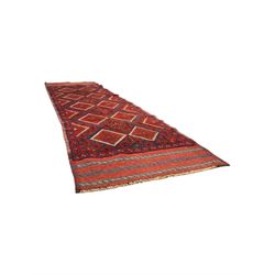 Pashtun Meshwani ground runner, central field decorated with rows of multicoloured diamond medallions, surrounded by geometric motifs, wide red and blue striped border with additional guard bands