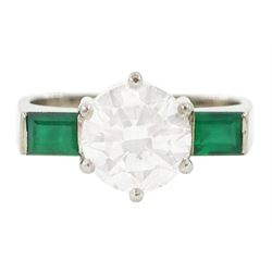 White gold three stone round brilliant cut diamond and baguette cut emerald ring, stamped ...