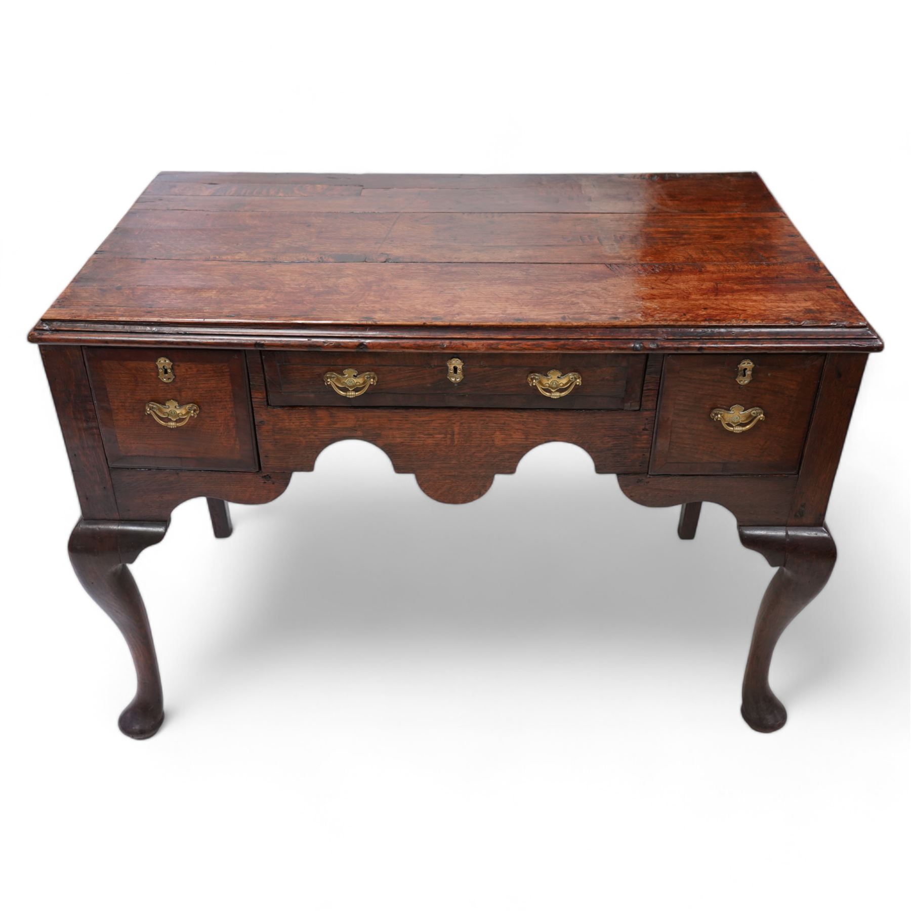 18th century oak low-boy, moulded rectangular top over three drawers and shaped apron, the mahogany banded drawer fronts fitted with shaped brass handles, on cabriole front supports and square tapering rear supports 