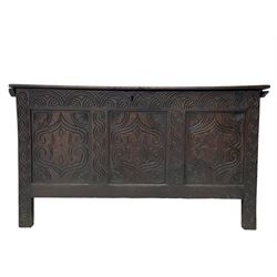 18th century oak blanket box, moulded and chip carved hinged lid, lunette carved cresting rail over triple panelled front carved with stylised leaf and scroll decoration, interlocking S-scroll carved upright rails, panelled sides and back, on stile supports 