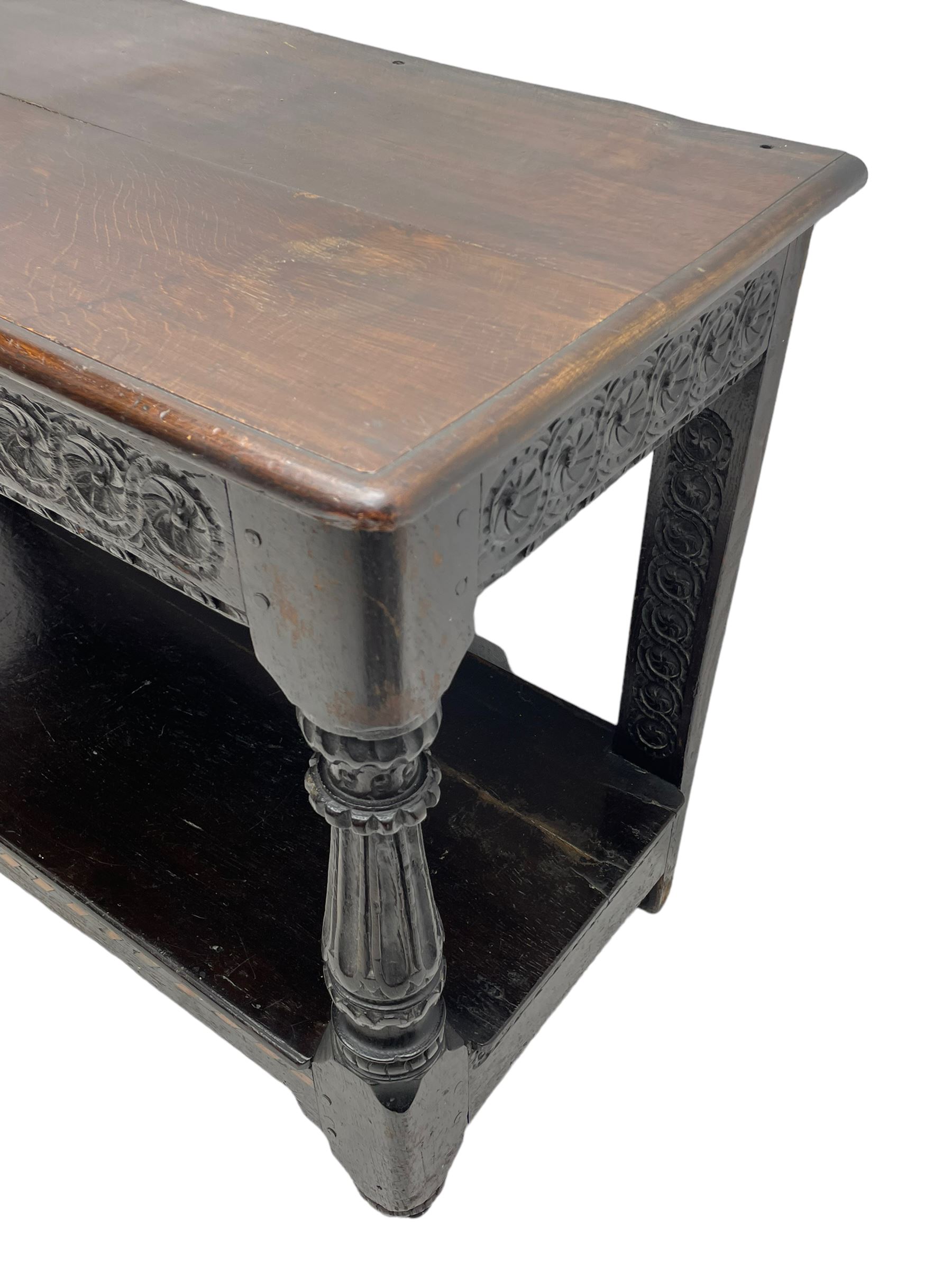  17th century oak buffet or side table, moulded rectangular top over guilloche carved frieze rails and rear upright supports, turned and flute carved front supports united by under tier