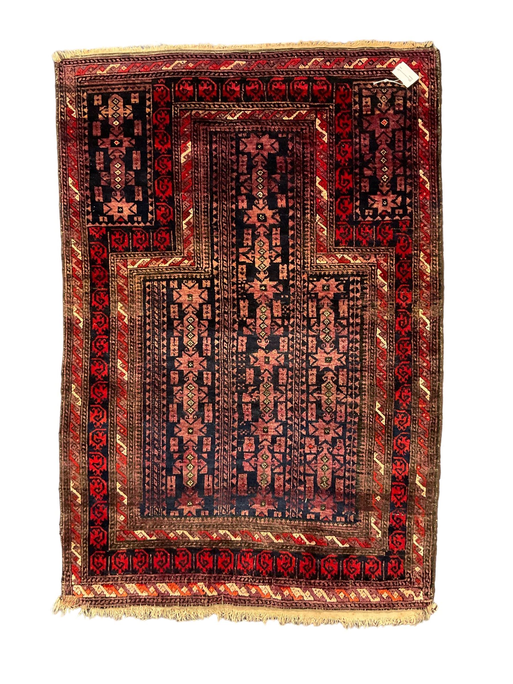 Bauchi prayer rug, dark indigo ground with overall geometric design within a flat arch border, multiple border bands with repeating geometric patterns