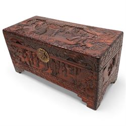 Chinese heavily carved and lacquered camphor wood blanket chest, rectangular hinged top, carved all-over with traditional figural and pagoda scenes with exotic birds, enclosed by a border of stylised clouds