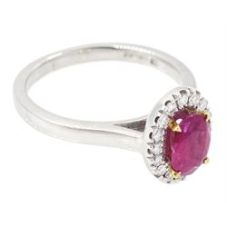 18ct white gold oval cut ruby and round brilliant cut diamond cluster ring, hallmarked, ruby approx 0.85 carat, total diamond weight approx 0.15 carat