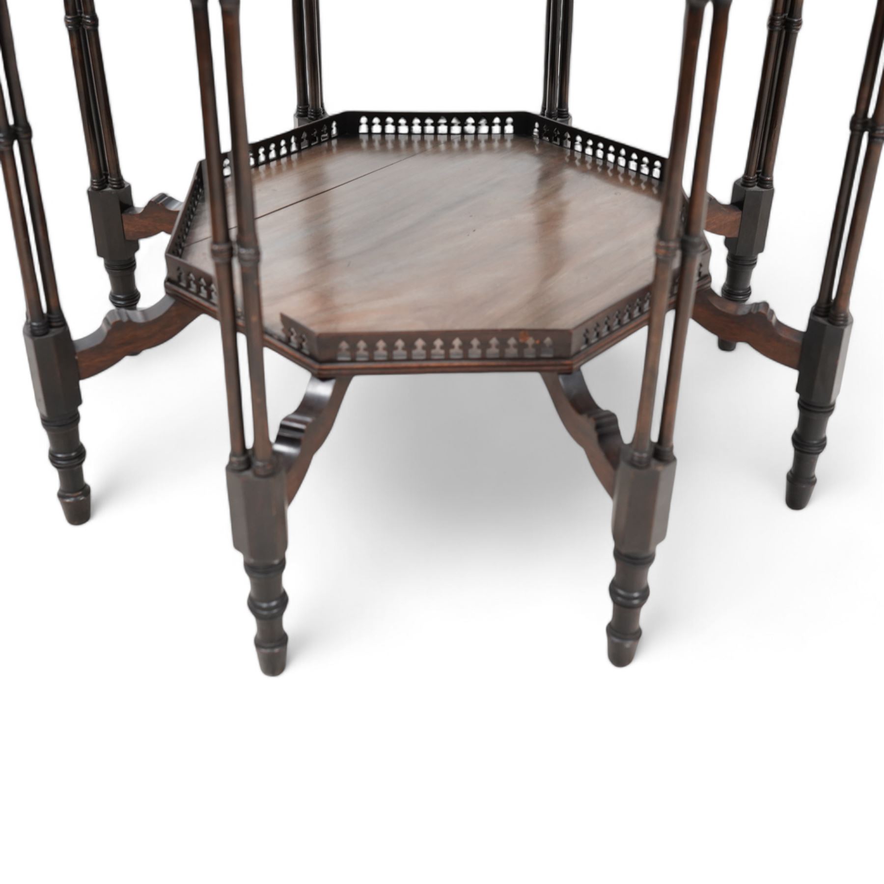 Late 19th to early 20th century mahogany octagonal centre table, moulded top over pierced arcade frieze rails and fretwork brackets, on eight cluster column supports terminating to turned feet, united by under tier with raised gallery 