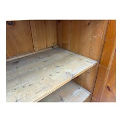 Large 19th century pine cupboard, rectangular top over two panelled later doors, enclosing four open shelves, on plinth base