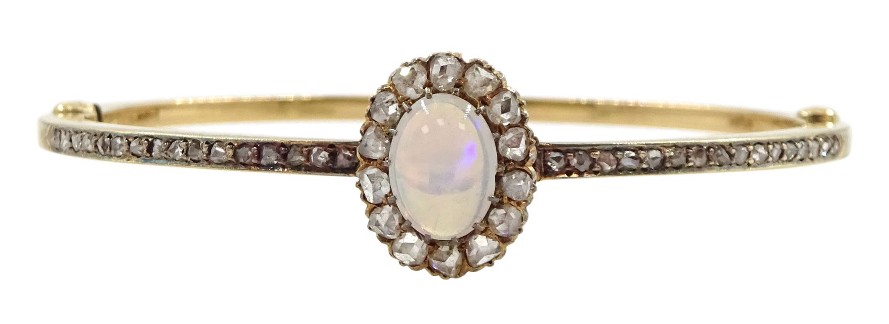 Early 20th century gold opal and diamond hinged bangle, the central opal and rose cut diamond cluster, with channel set rose cut diamonds set either side