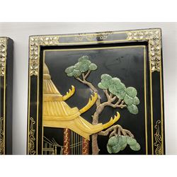 Two 20th century Chinese lacquered wall plaques, decorated in relief with female figures playing instruments beneath a pagoda, within gilt and mother of pearl inlaid borders, H92cm