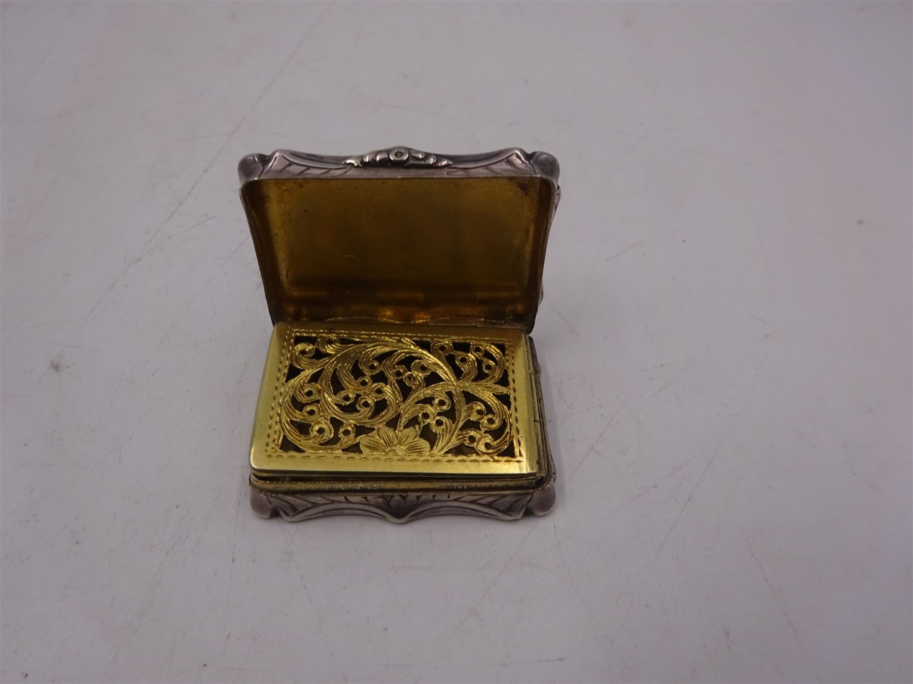 Victorian silver vinaigrette, with engraved name and scrolling decoration to hinged cover, the gilt interior with typical pierced cover, hallmarked Nathaniel Mills, Birmingham 1841, W3.7cm