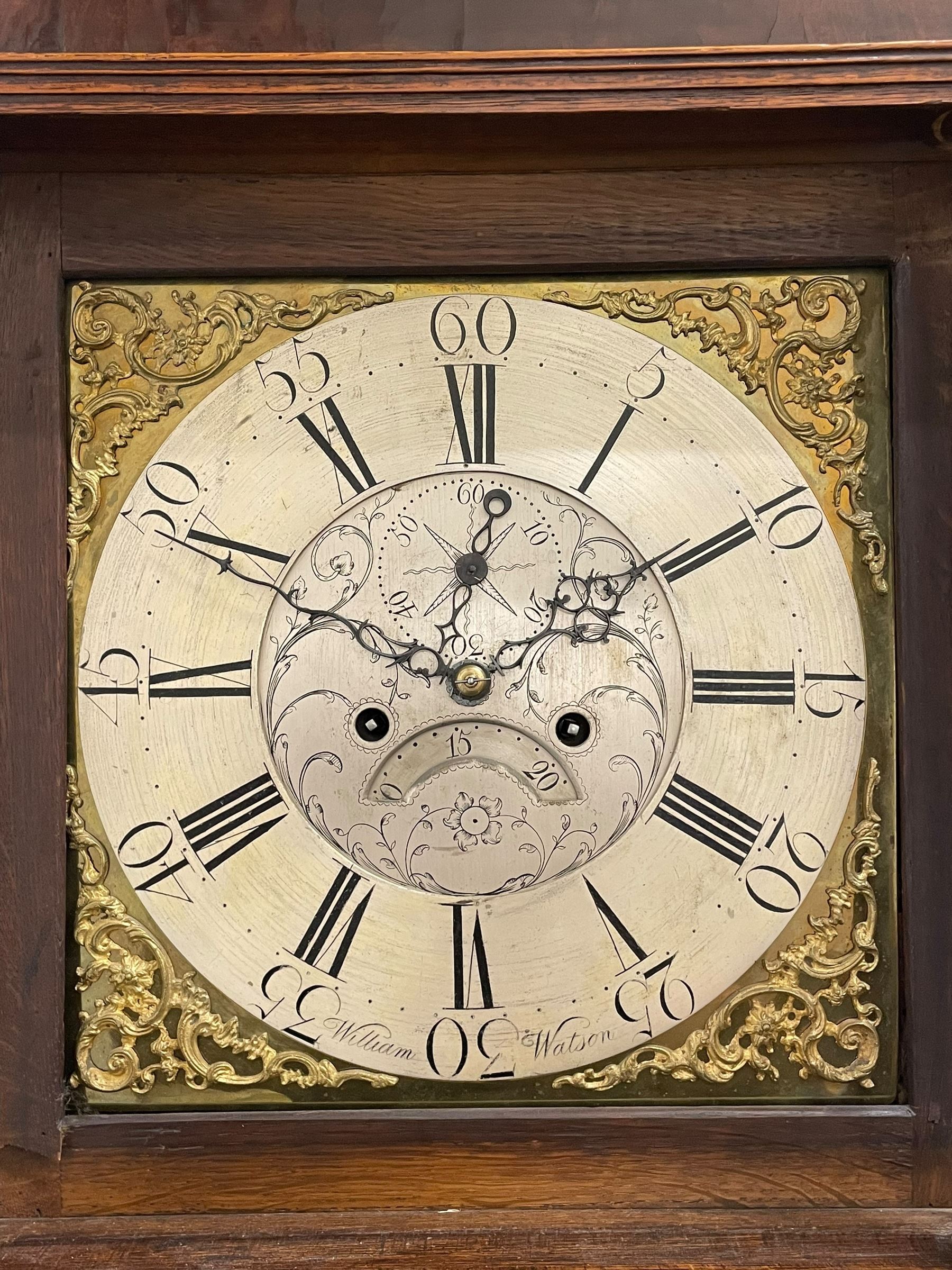 William Watson of  Blackburn (Lancs)  - late 18th century 8-day oak and mahogany cross banded longcase clock, with a flat top and open fretwork above, deep cornice with dogtooth moulding and frieze beneath, square hood door flanked by reeded pilasters with brass capitals, trunk with  reeded quarter columns, long trunk door with concave corners on a plinth with canted corners on bracket feet, brass dial with cast brass spandrels, broad silvered chapter ring with Roman numerals and five-minute Arabic's, a profusely engraved and silvered dial centre with seconds dial, matching steel hands and calendar aperture, hourly rack striking movement with a recoil anchor escapement. With weights, pendulum and key. 
William Watson of Northgate, Blackburn, is recorded as working c1770-1814 . As with this clock he frequently signed some of his clocks without a placename.