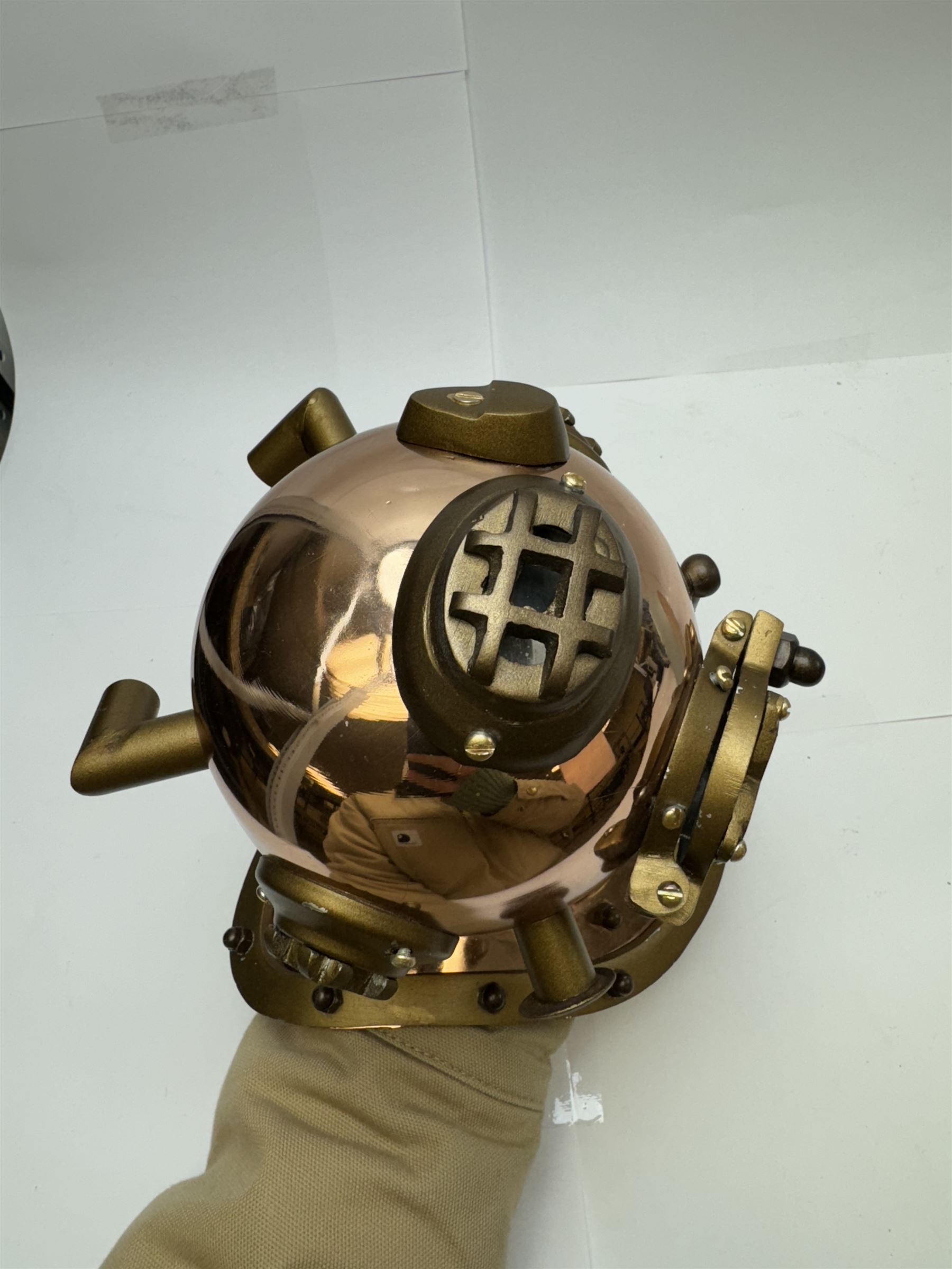 Copper novelty miniature diving helmet, together with underwater camera, helmet H20cm