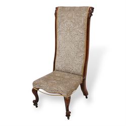 Victorian rosewood prie dieu chair, the ears carved with curl leaves, upholstered in foliate pattern fabric, cabriole feet on brass castors 