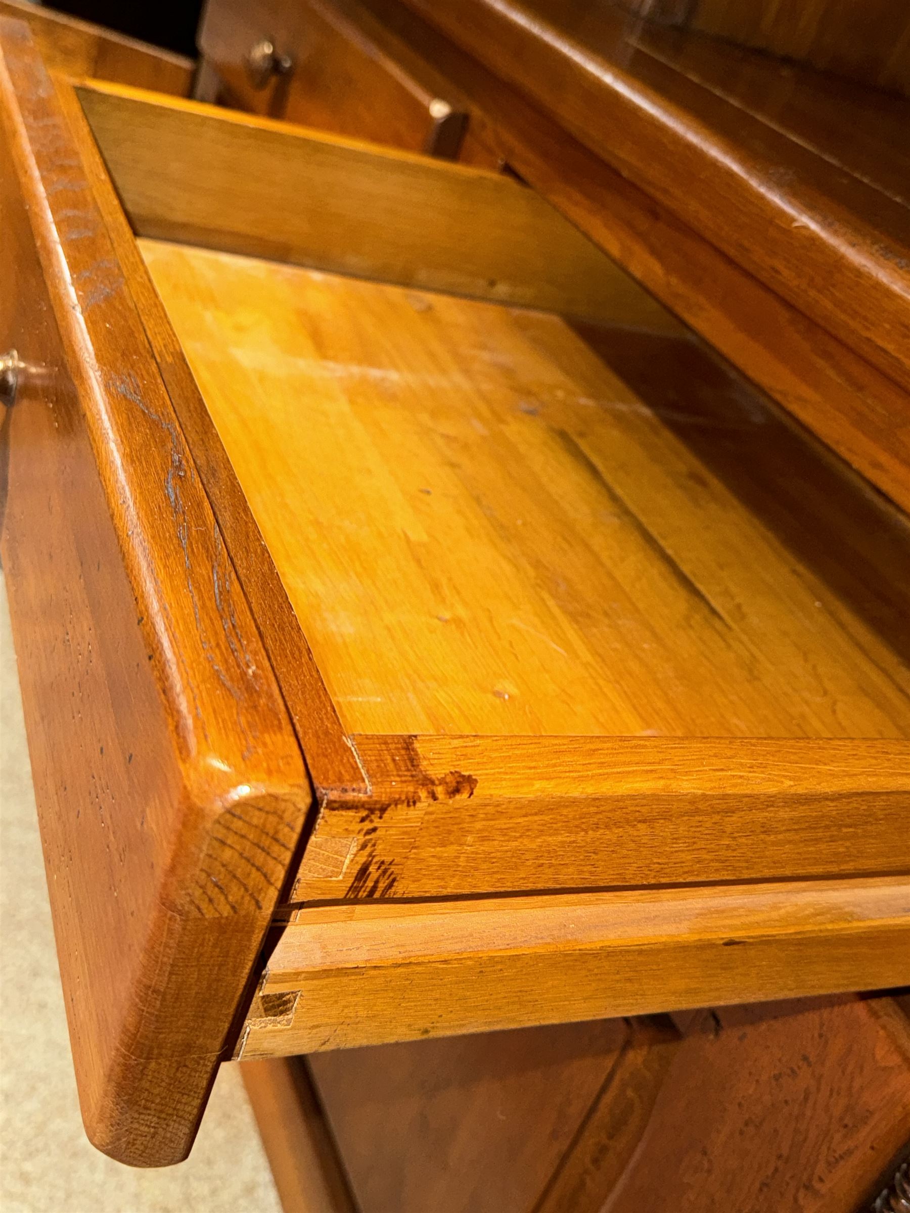 Large 20th century oak dresser, projecting cornice over open arched central section with two shelves, flanked by two panelled cupboards with two shelves, lower section with three drawers above three cupboards, on stile supports 