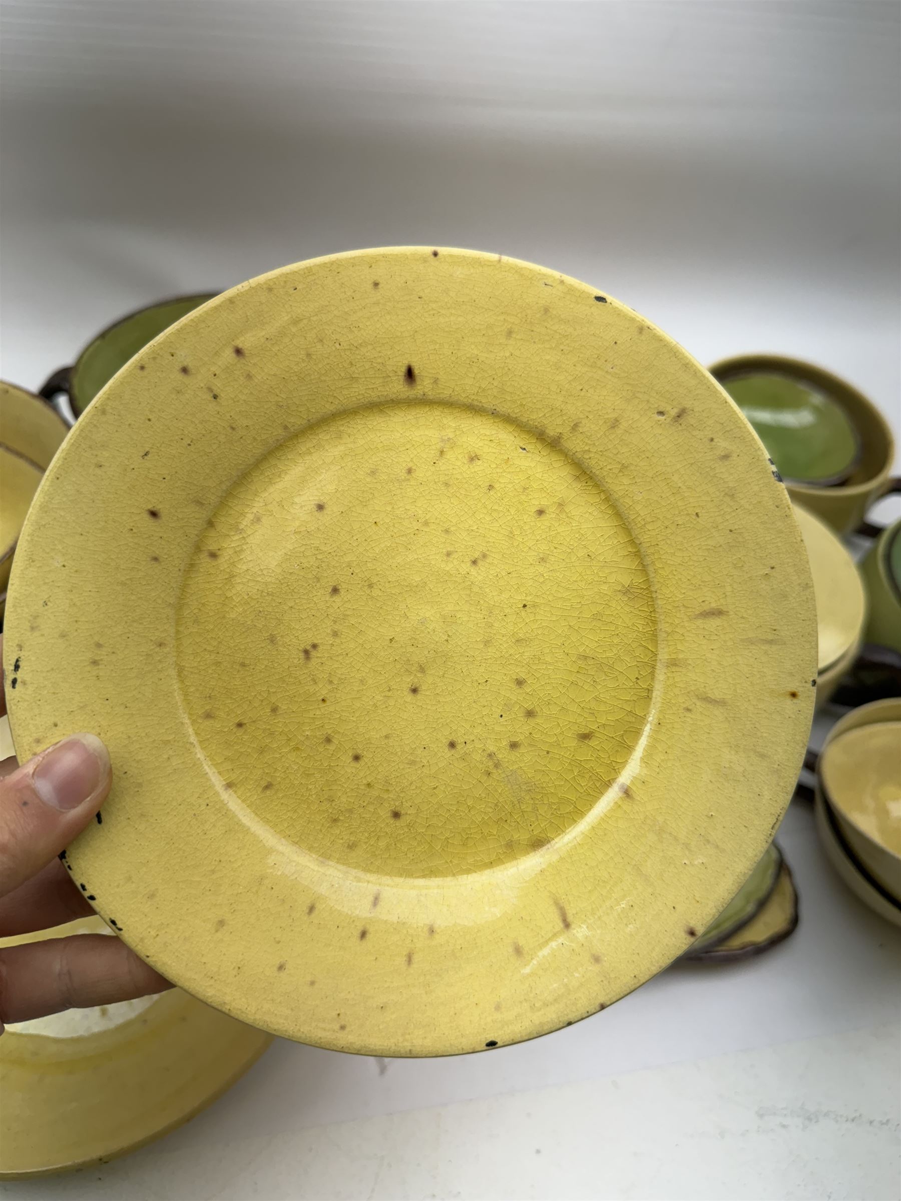 French green and yellow glazed tea and dinner wares by Etienne Noel, including milk jugs, teacups, side plates, bowls etc (43)