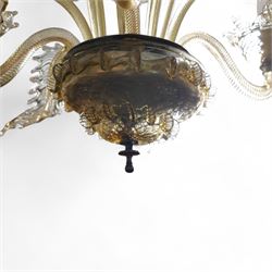 Mid-to-late 20th century Murano glass four branch chandelier, elongated baluster stem with foliate decoration, each segment with hot-work decoration, four serpentine branches interspersed with twisting acanthus leaves, each branch fitted with bobeche, surmounted by eight arms of alternating glass flowers and leaves 