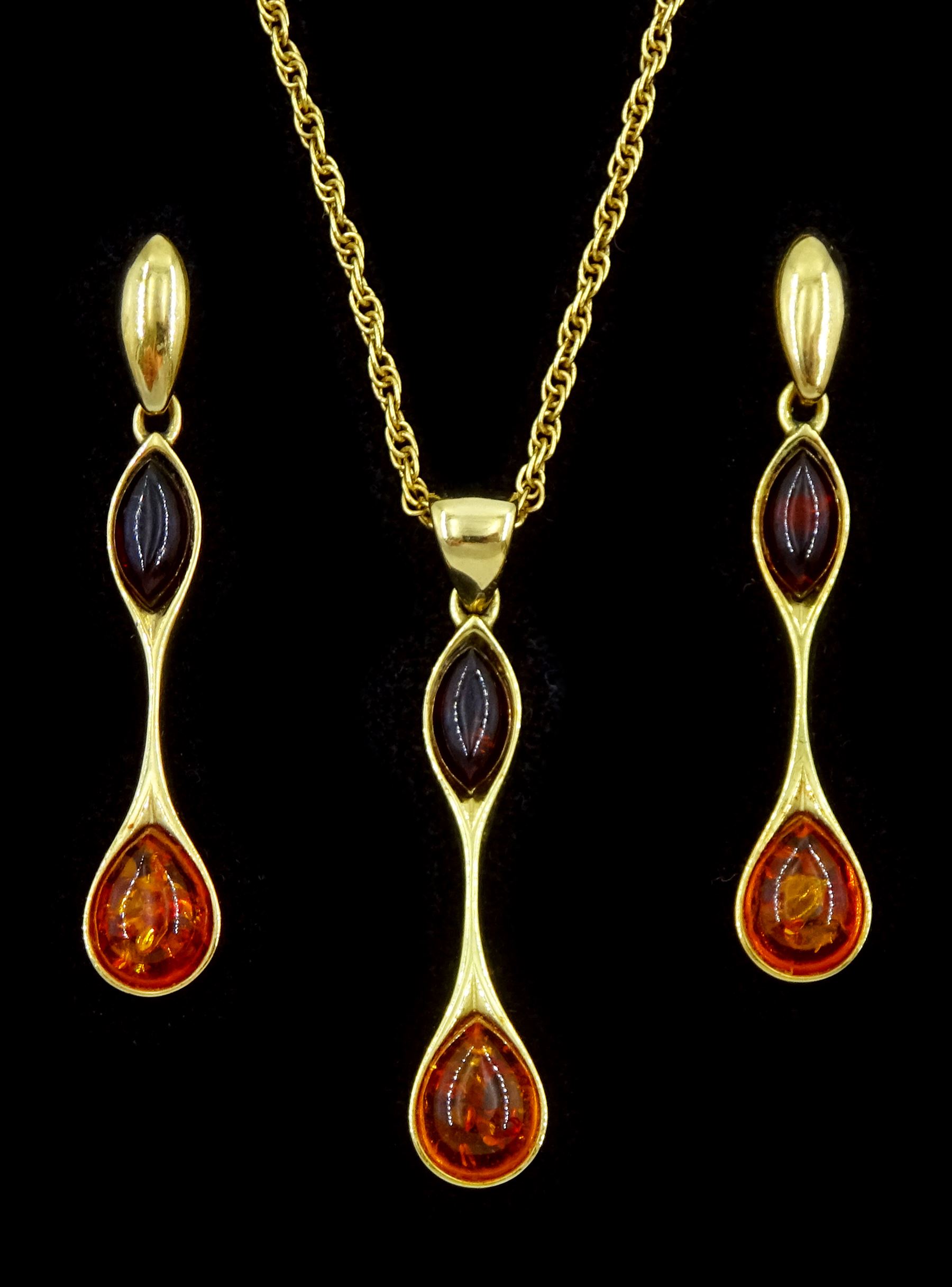 Gold two tone amber pendant necklace and a pair of gold matching stud earrings, all 9ct