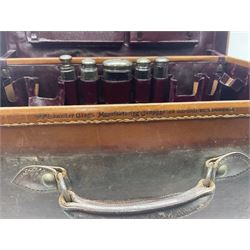 Early 20th century leather bound travelling case, with initials to cover, with fitted interior containing five silver topped glass jars, each engraved with initials, hallmarked The Alexander Clark Manufacturing Co, London 1910 & 1911, case W61cm