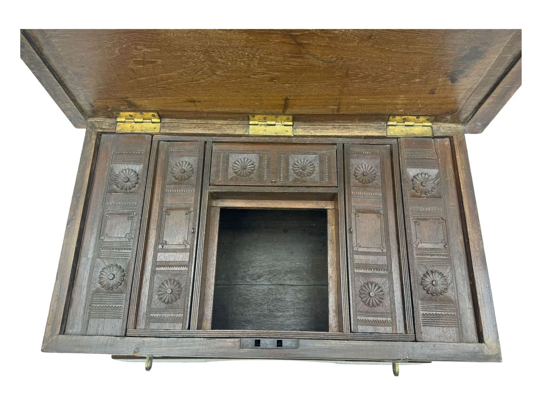 20th century mahogany chest, rectangular hinged top enclosing removable compartments with carved starburst motifs with linear and geometric patterns, brass inlay to the top and front, mounted corners and edges, on bracket base