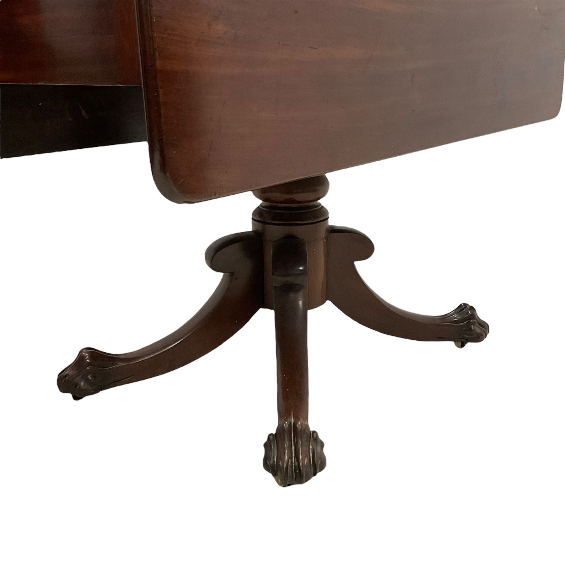 Victorian mahogany Pembroke supper table, fitted with single drawer, drop-leaf top on turned pedestal, four splayed supports with large carved paw feet on castors