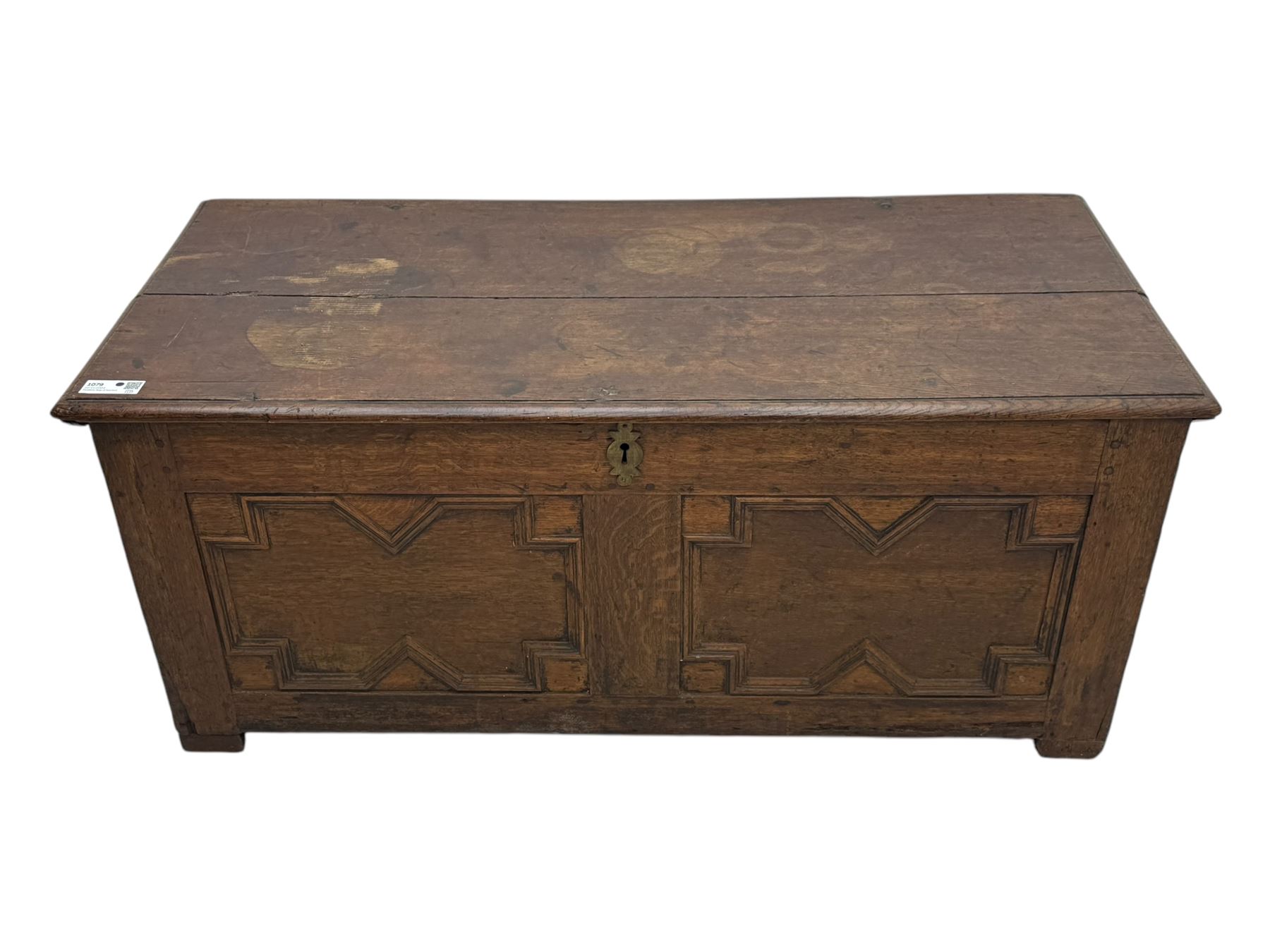 18th century oak blanket box, rectangular form with a hinged lid, the front decorated with raised geometric panelled mouldings, fitted with a central lock plate, raised on bracket feet