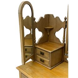 Late Victorian satin walnut dressing table, central mirror with carved crest flanked by two adjustable side mirrors, each supported by turned uprights, the base fitted with two short over two long drawers with brass handles, resting on bracket feet