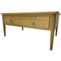 Contemporary light oak rectangular coffee table, fitted with single drawer disguised as two drawers to each side, on tapering supports