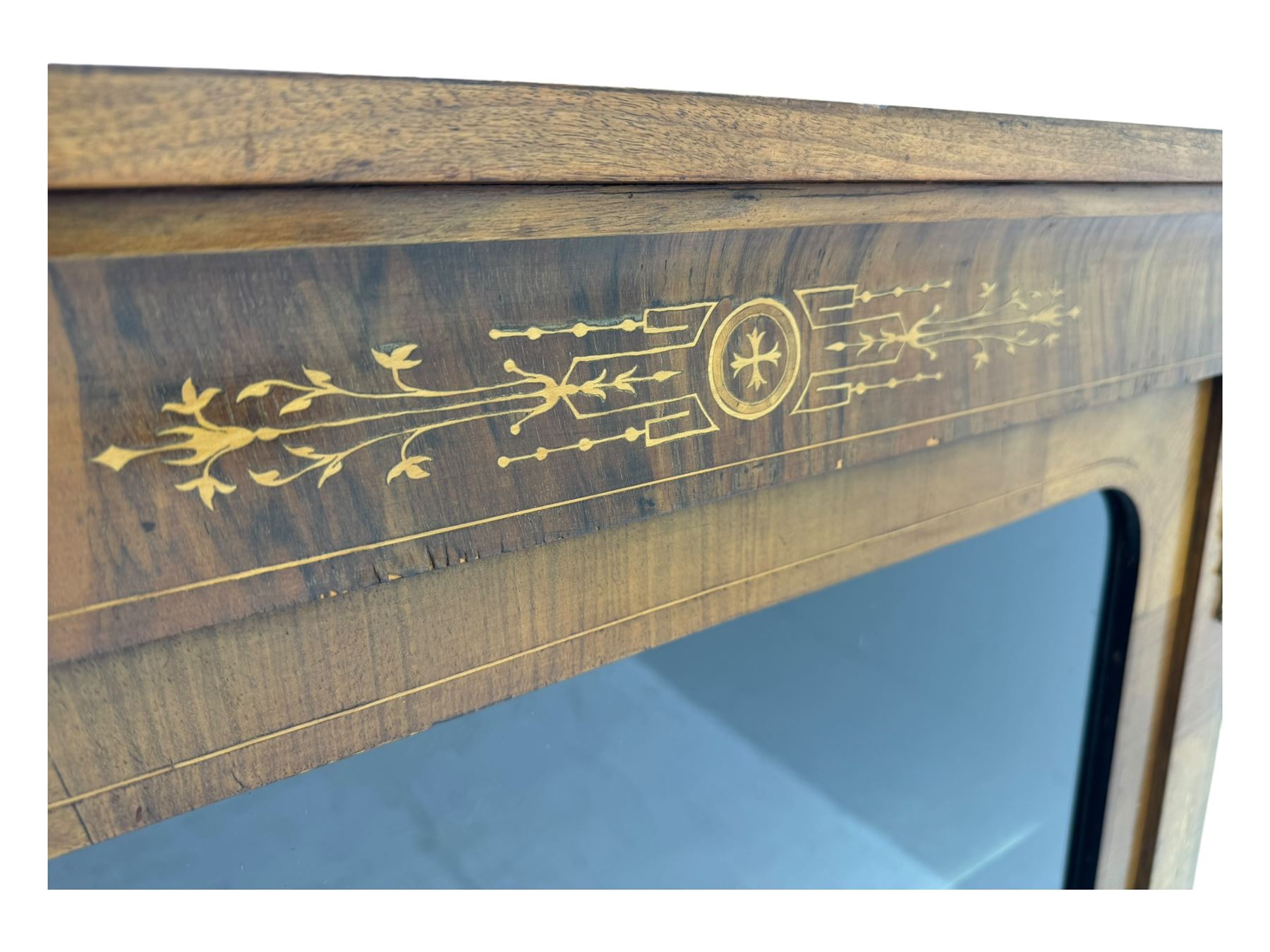 Late Victorian walnut pier cabinet, projecting cornice over frieze inlaid with foliate motifs, single glazed door flanked by ormolu mounts, enclosing shelved interior, on plinth base