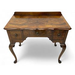 Mid-to-late 20th century figured walnut side table, raised back over figured top with cross banding and shaped front, fitted with three drawers, on cabriole supports with carved terminals 