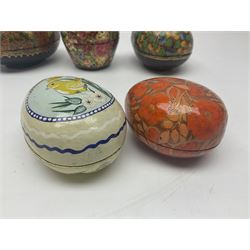 Seven lacquered boxes, of ovoid form, with floral decoration, largest H7cm, L10cm