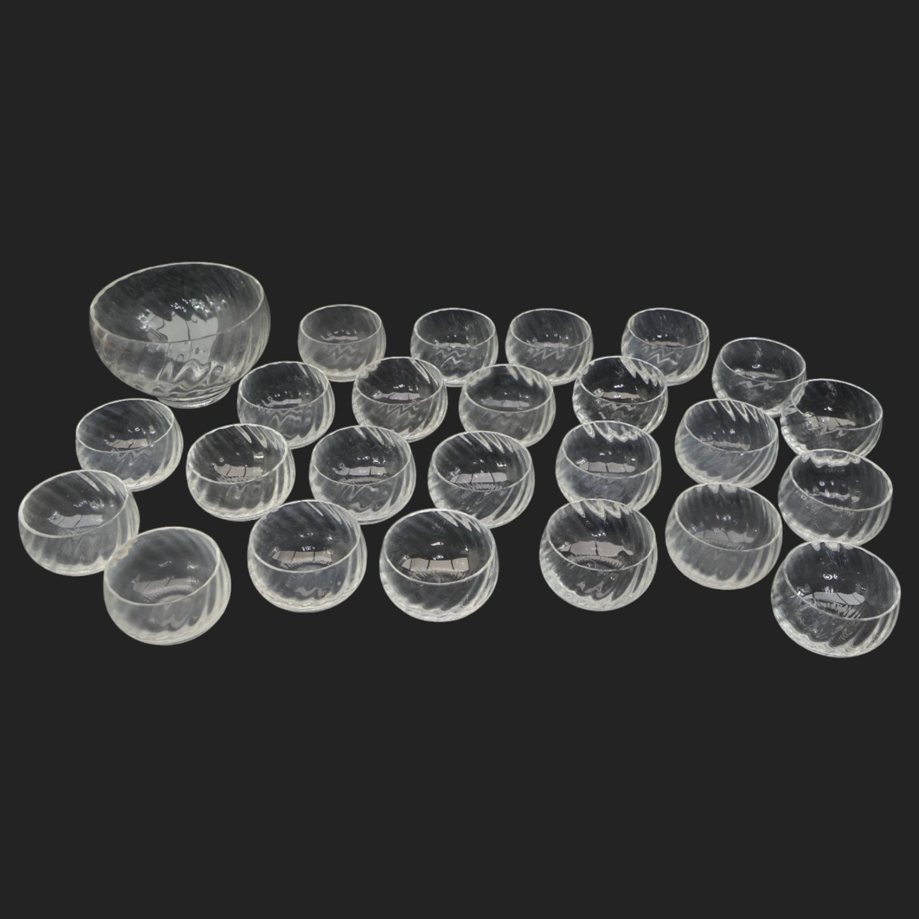 Dartington Ripple pattern fruit set comprising thirty bowls and serving bowl and a number of plain glass champagne saucers