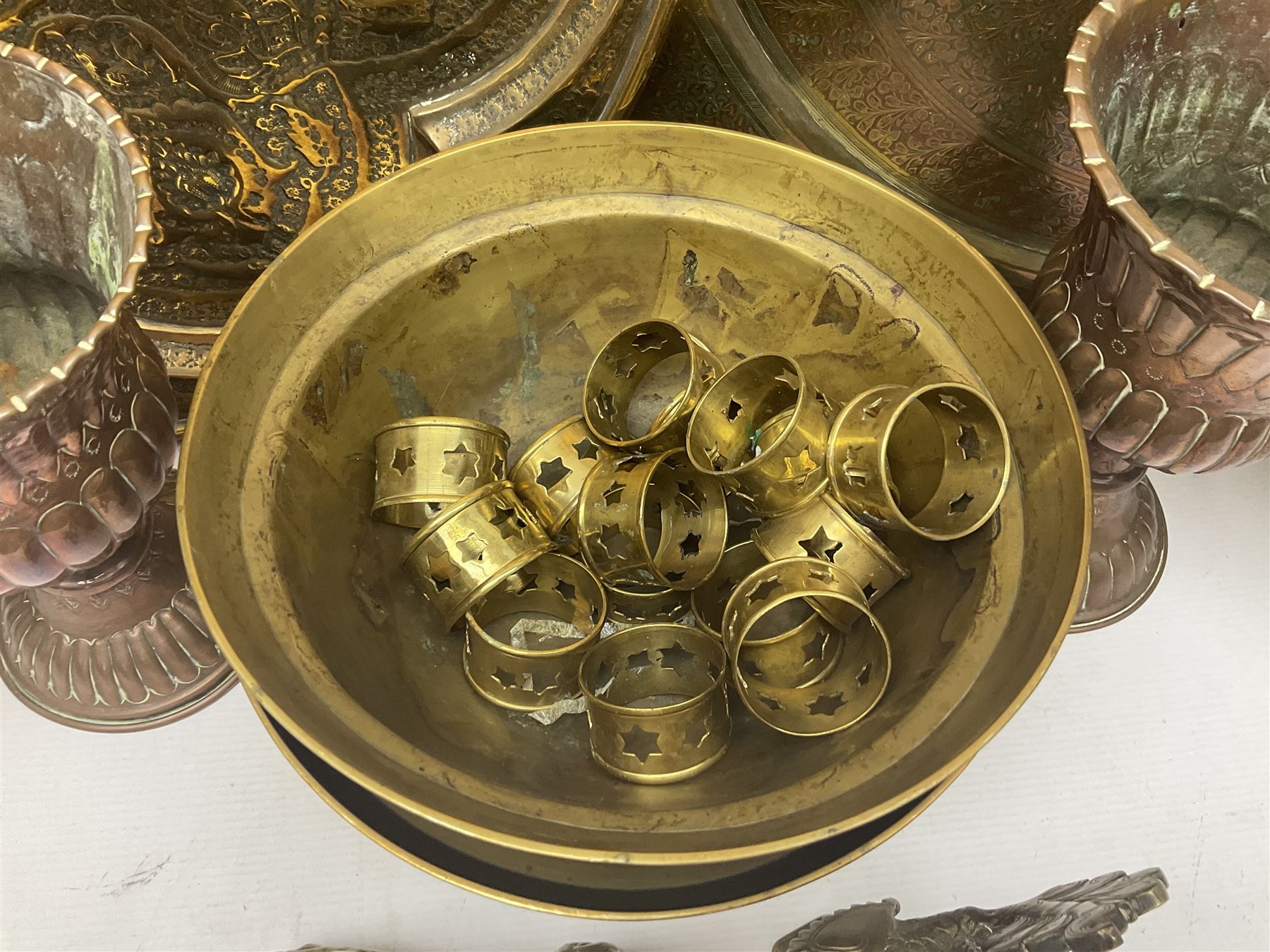 Collection of oriental brass and other metal ware, to include to large chargers, pair of covered urns, hoho bird, etc, largest charger D63cm