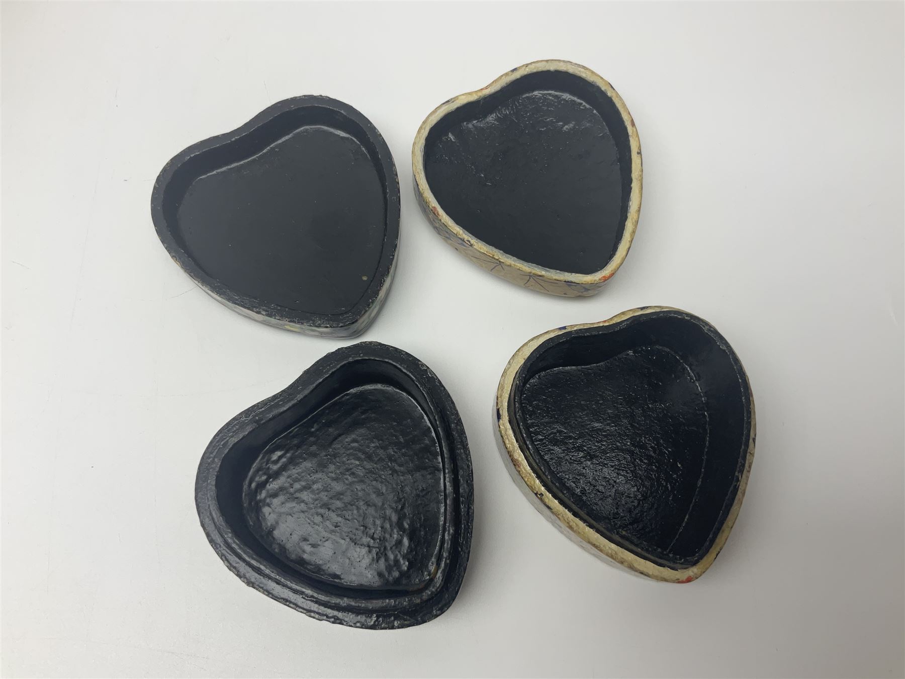 Nine lacquered boxes, including seven heart shaped examples, mainly decorated with floral designs, largest H12cm