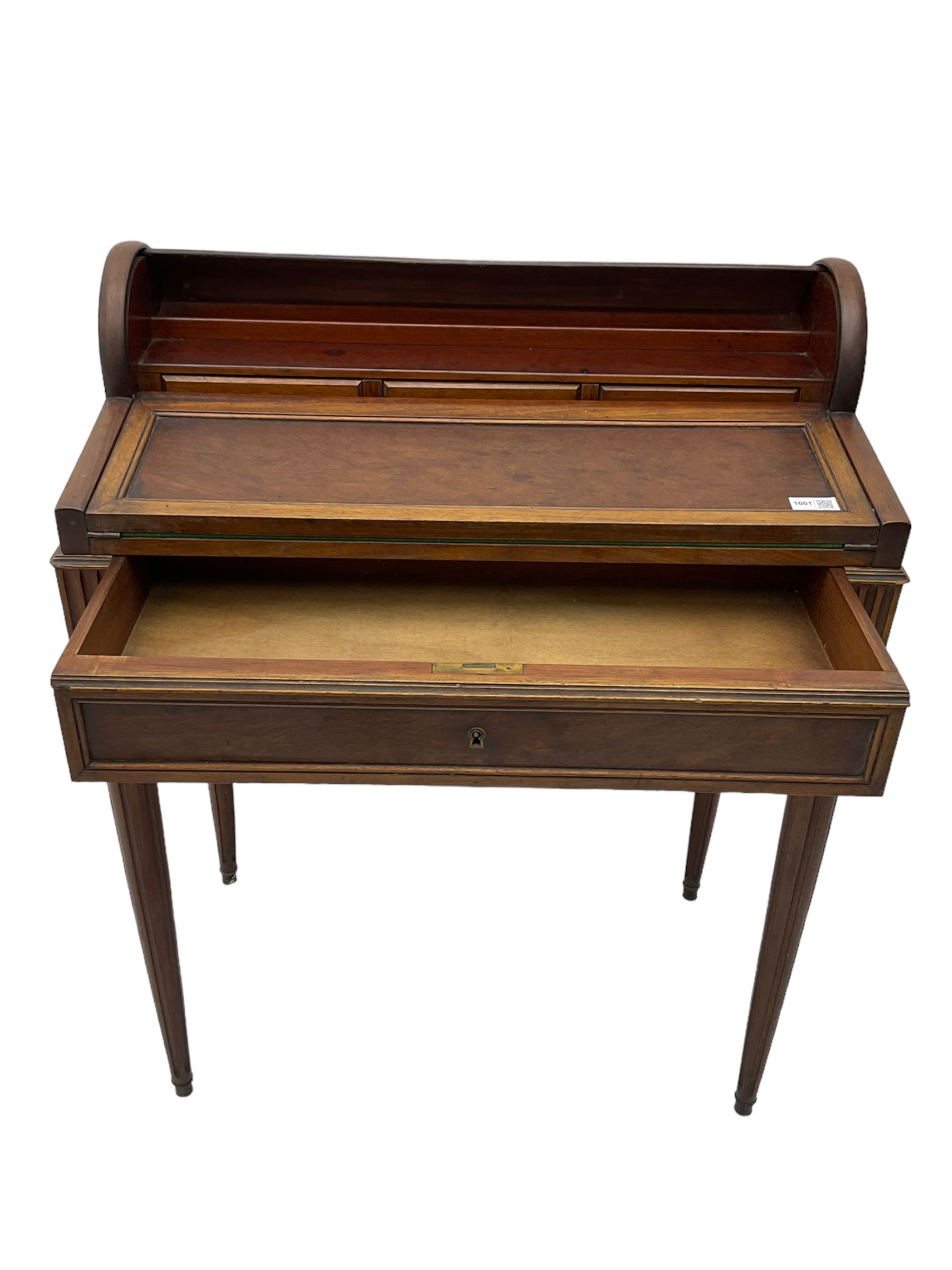 Early 20th century French plum pudding mahogany petite writing desk, barrel tambour roll top, fitted with a single cock-beaded drawer activating the tambour roll, the fold-over writing slope with inset writing surface supported by long drawer, fitted with three small drawers and pen rail, raised on fluted tapering supports