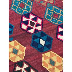 South West Persian Qashqai Kilim, crimson ground and decorated with three rows of geometric motifs, within zig-zag borders 