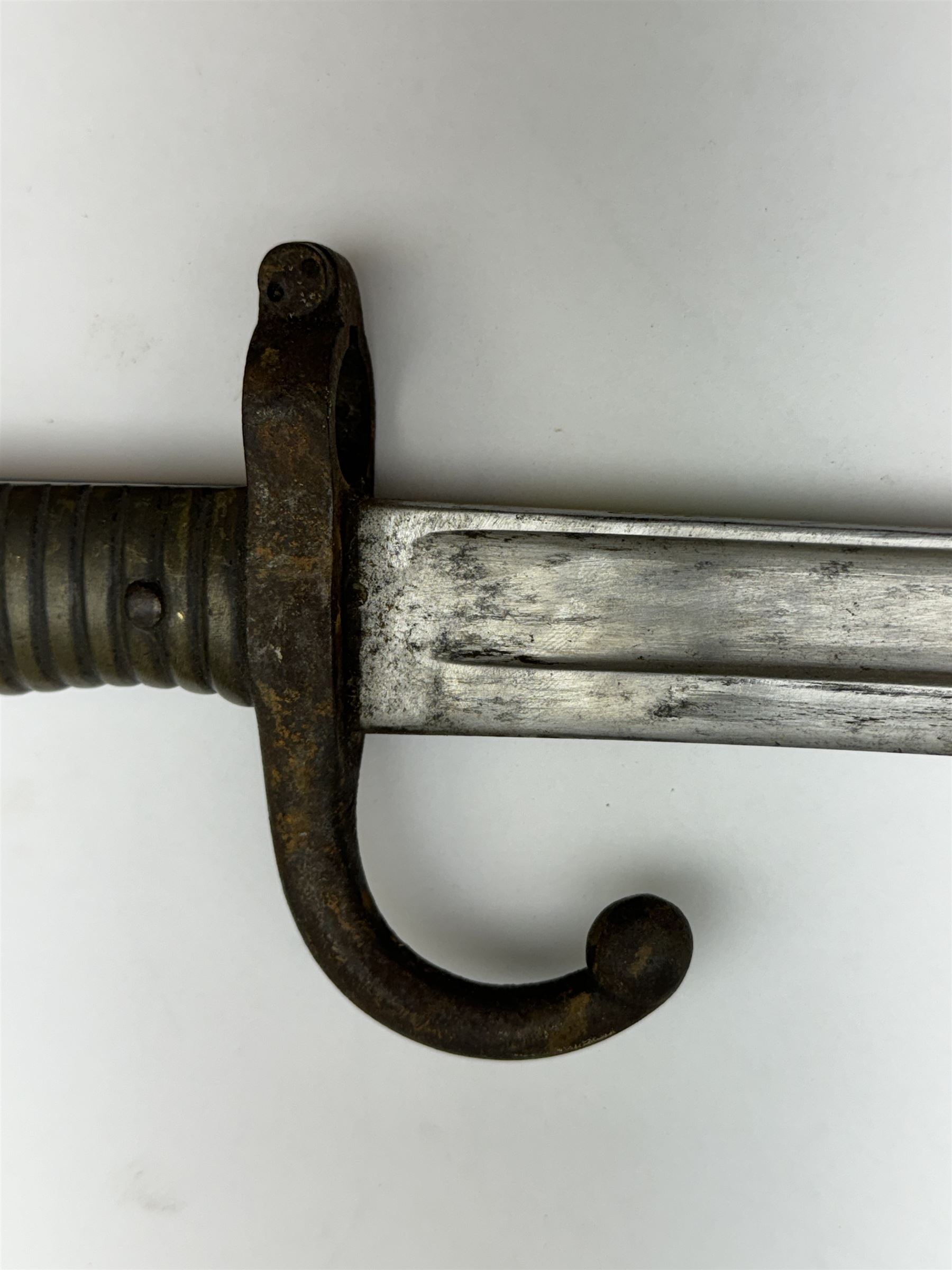 WWI French Chassepot Sword bayonet 57cm steel blade inscribed to the back-edge 'Tulle Juillet 1874', the cross-guard with indistinctly impressed number, in its steel scabbard, L71cm