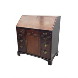 George III mahogany bureau, the fall-front enclosing fitted interior with pigeonholes and central cupboard, over an arrangement of nine short drawers surrounding a central cupboard, on shaped bracket feet