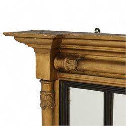 Regency gilt wood overmantel mirror, moulded cornice with projecting square ends, fitted with three turned column mounts with foliage decoration, ebonised and reed moulded slip dividing the mirror into three sections, moulded lower rail, plain mirror plates