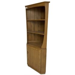 Ercol - mid-20th century '743C'  light elm corner cabinet, fitted with two open shelves over a single cupboard