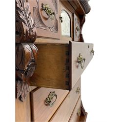 Late Victorian walnut Scotch chest, projecting cornice with turned quarter column mounts over matching half column to frieze, fitted with two upper short drawers with central cupboard, bevelled mirror glazed cupboard door, four graduating drawers below, foliage and flower head carved brackets to the uprights, panelled sides, chamfered plinth on turned feet