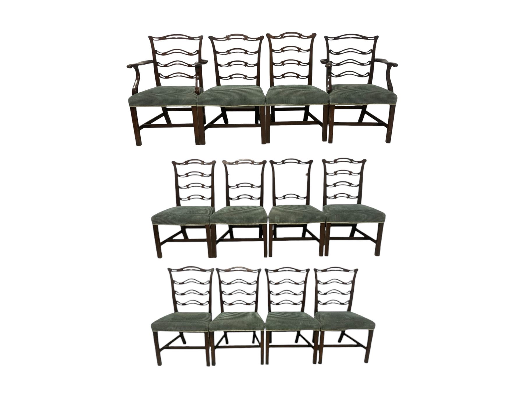 Set of twelve (10+2) Chippendale revival stained beech dining chairs, pierced waived ladder backs with over-stuffed over seats, on square moulded supports joined by stretchers