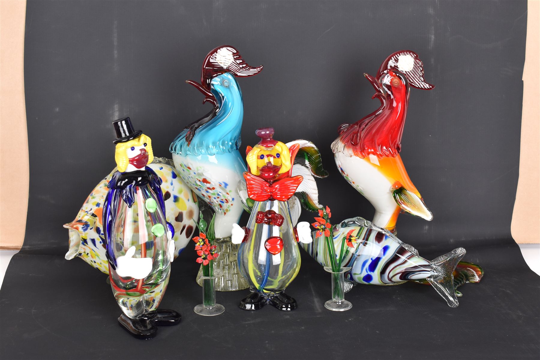 Two Murano glass clowns, together with similar glass figures, including cockerels and fish