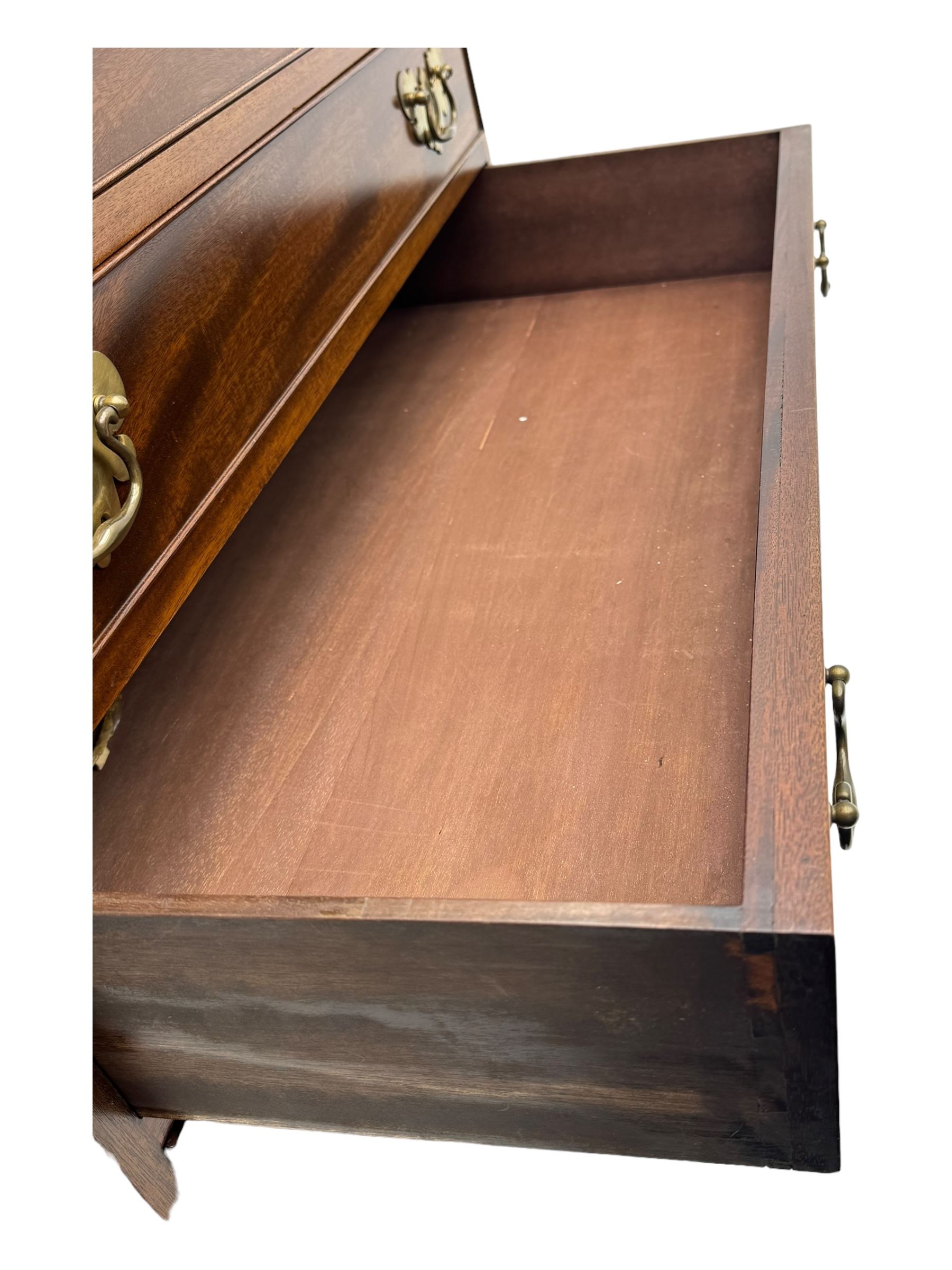 Mid-to-late 20th century inlaid mahogany bureau, inlaid floral medallion to the top, the fall front opening to reveal fitted interior with pigeonholes, small drawers and central cupboard, green inset writing surface with gilt tooling, four drawers below with brass handles, raised on shaped bracket feet