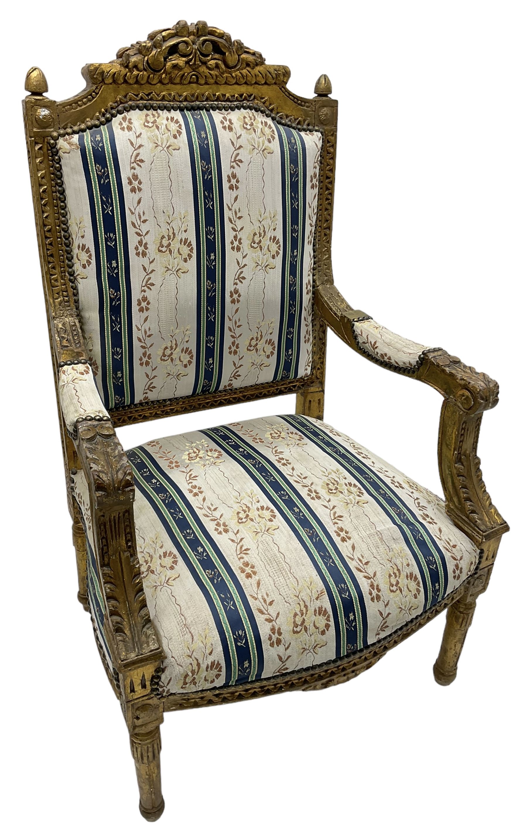 Late 20th century French design carved giltwood armchair, the cresting rail carved with scrolled foliage over foliate carved platform, upholstered in striped fabric decorated with trailing foliage and flower heads, acanthus carved arm terminals and upright supports, on turned and fluted supports 