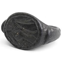 Bronze seal ring, possibly Roman, with D shaped hoop and angled shoulders, the bezel engraved with a figure, possibly on horseback 