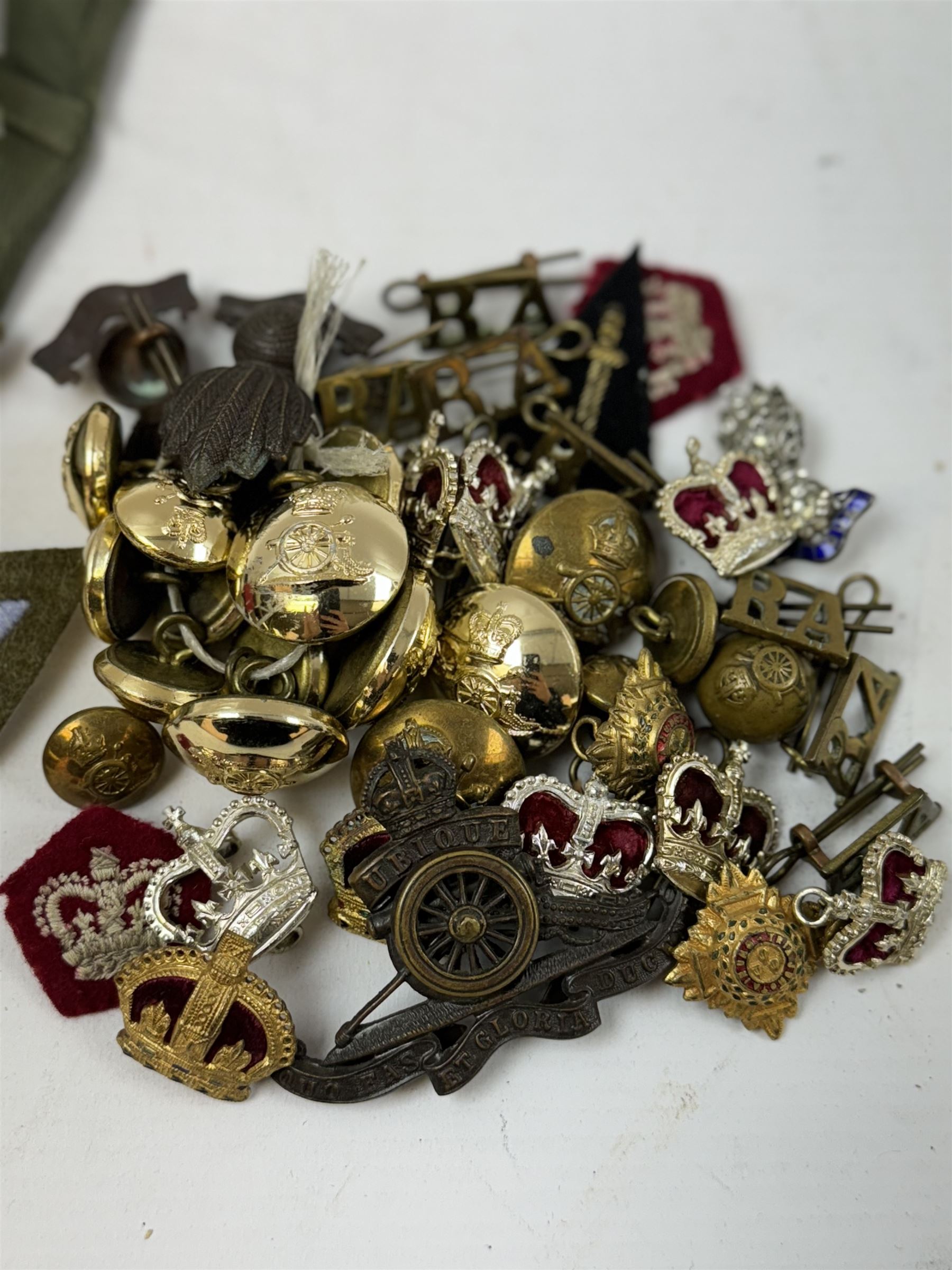 Various cloth and metal military badges including cap and collar badges, rank crowns and stars, staybrite button etc